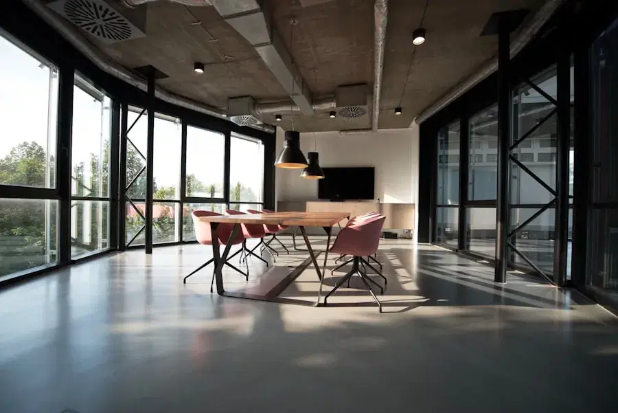 Sunlit meeting room with a long table and floor-to-ceiling windows