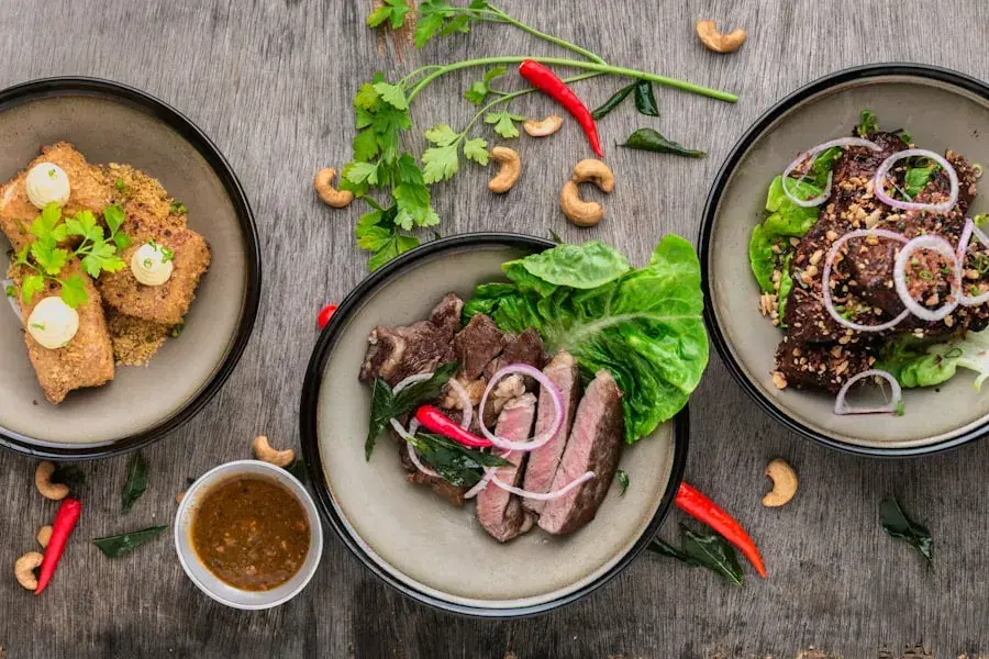 Plates of grilled food and salad on a wooden table