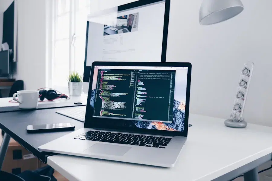 Laptop showing code on a white desk